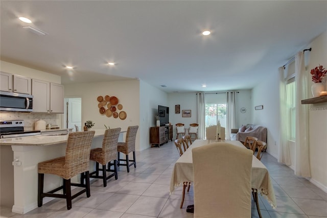 dining area with sink and light tile patterned floors