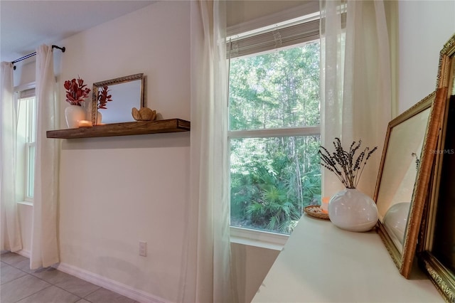 doorway featuring light tile patterned flooring and a wealth of natural light