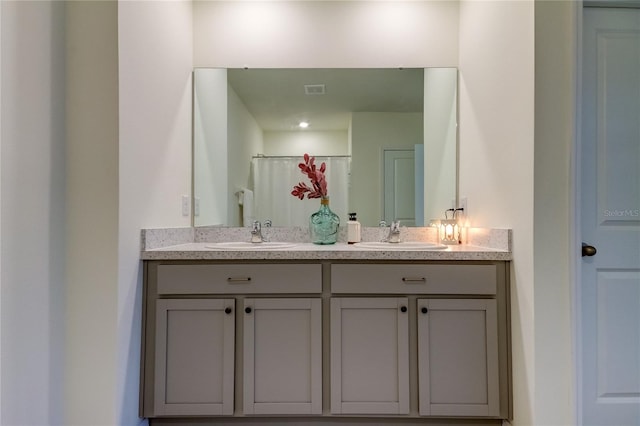 bathroom featuring curtained shower and vanity