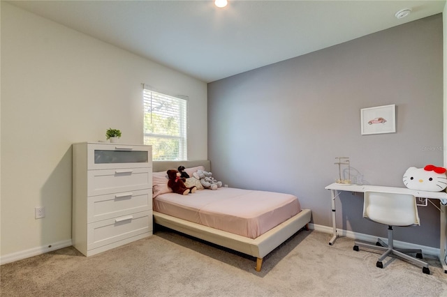 bedroom featuring light carpet