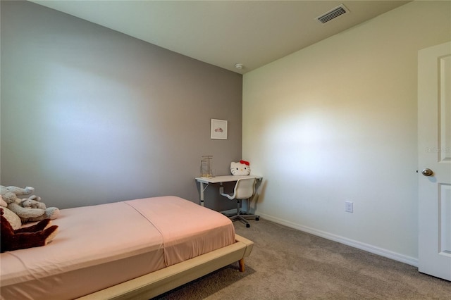 bedroom with light colored carpet