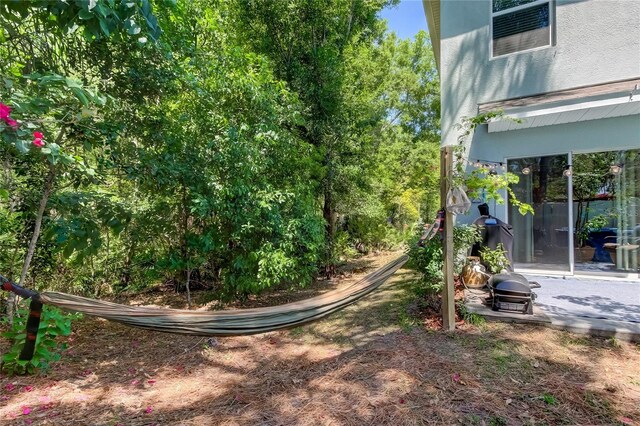 view of yard with a patio and an outdoor fire pit