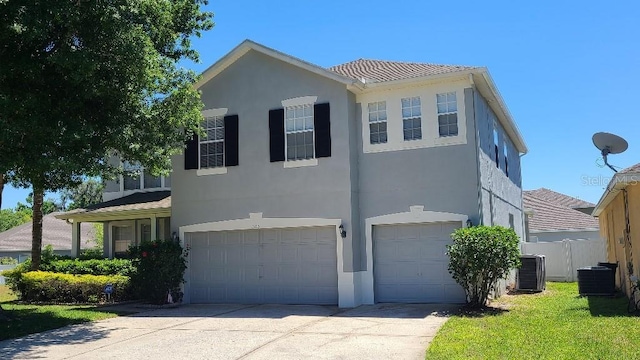 view of front facade with central AC unit and a garage