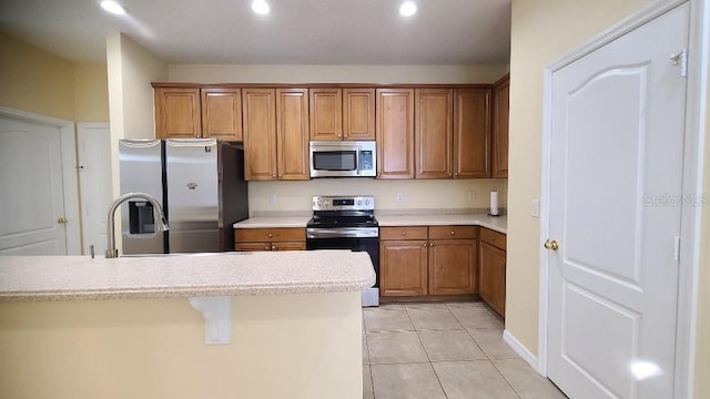 kitchen with sink, light tile floors, and stainless steel appliances