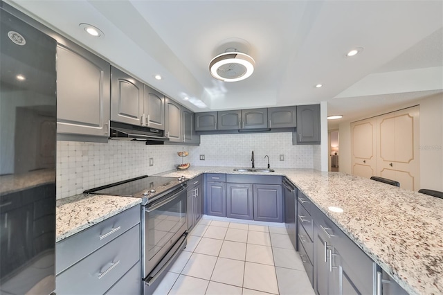 kitchen featuring light stone counters, backsplash, electric range, light tile floors, and range hood