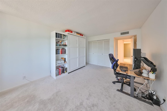 office featuring a textured ceiling and carpet