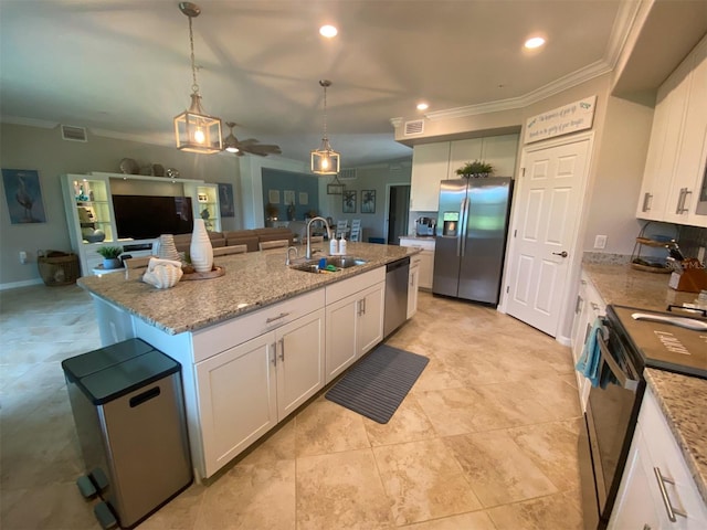 kitchen featuring white cabinetry, stainless steel appliances, sink, and an island with sink