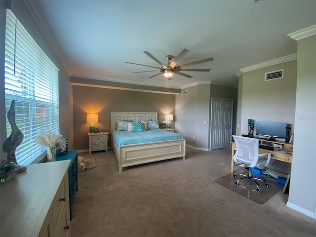 carpeted bedroom with a closet, ceiling fan, and ornamental molding