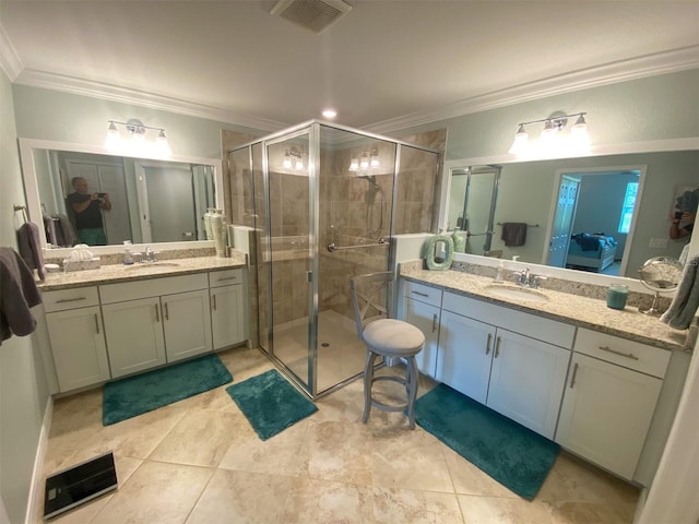 bathroom featuring vanity, ornamental molding, and a shower with door