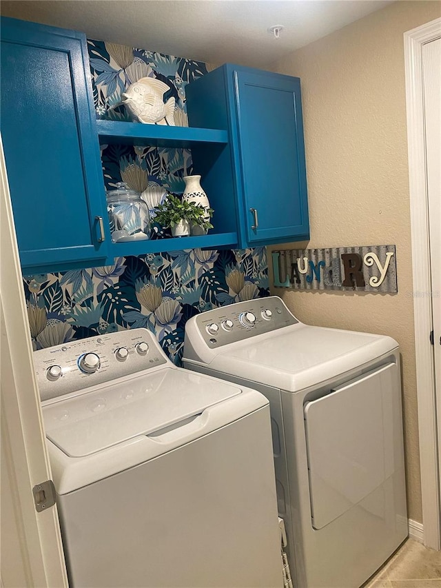 washroom with cabinets, light tile patterned flooring, and washing machine and dryer