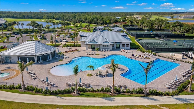 view of pool with a patio and a water view