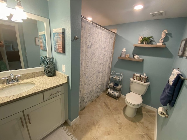 bathroom with vanity, toilet, and tile patterned flooring