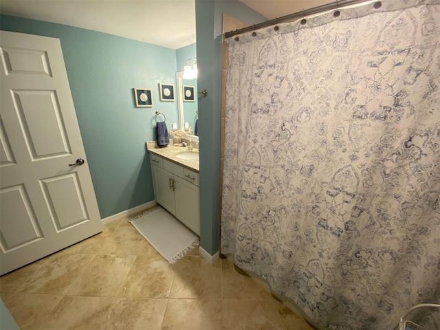 bathroom with vanity, walk in shower, and tile patterned flooring