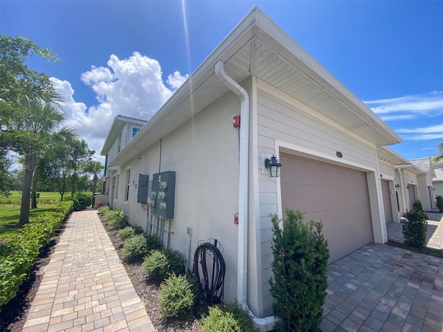 view of side of home featuring a garage