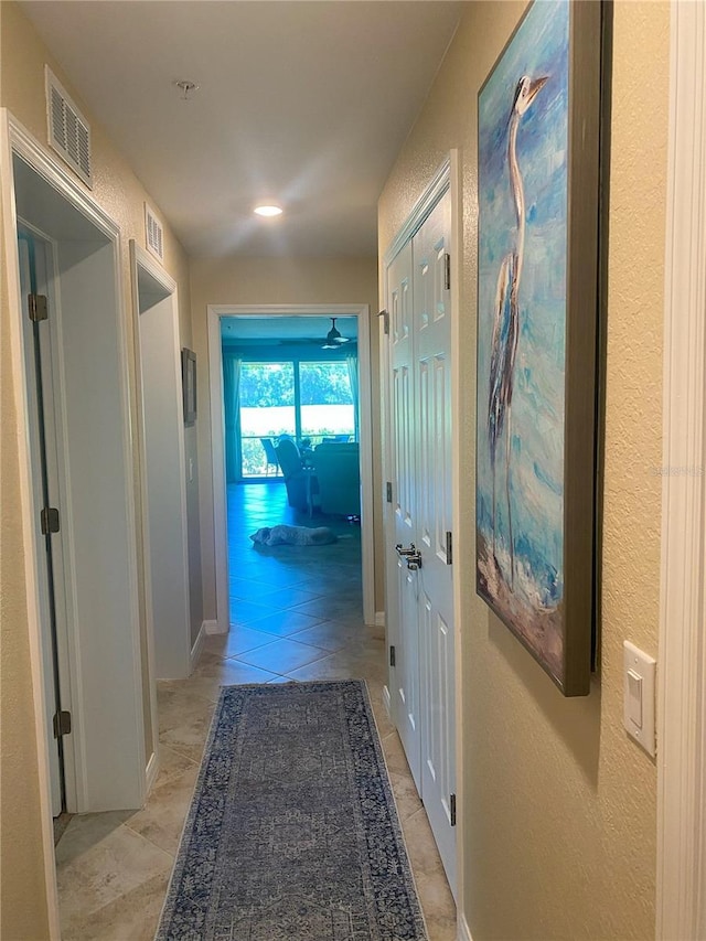 hall featuring light tile patterned floors