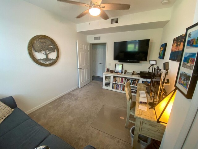 carpeted living room featuring ceiling fan