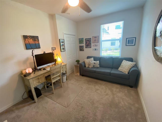 carpeted office space featuring ceiling fan