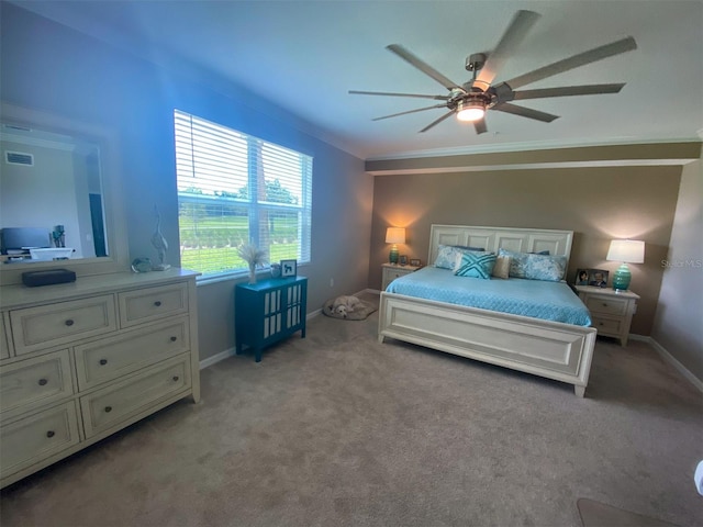 carpeted bedroom with ornamental molding and ceiling fan