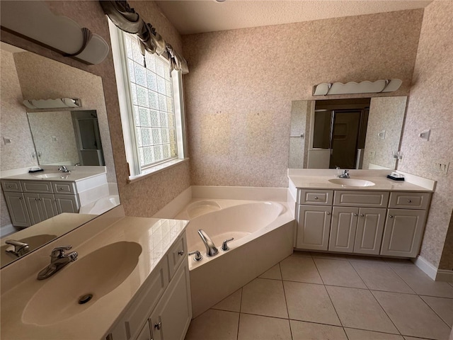 bathroom featuring vanity with extensive cabinet space, double sink, tile flooring, and a bathing tub