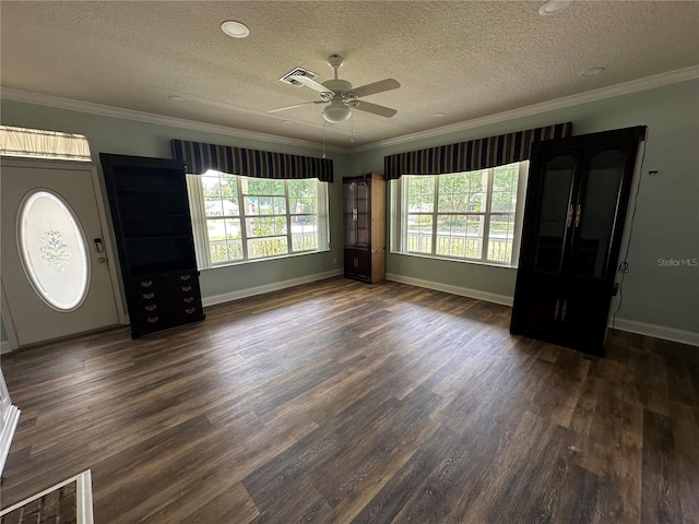 foyer entrance featuring ceiling fan, ornamental molding, dark hardwood / wood-style flooring, and a textured ceiling