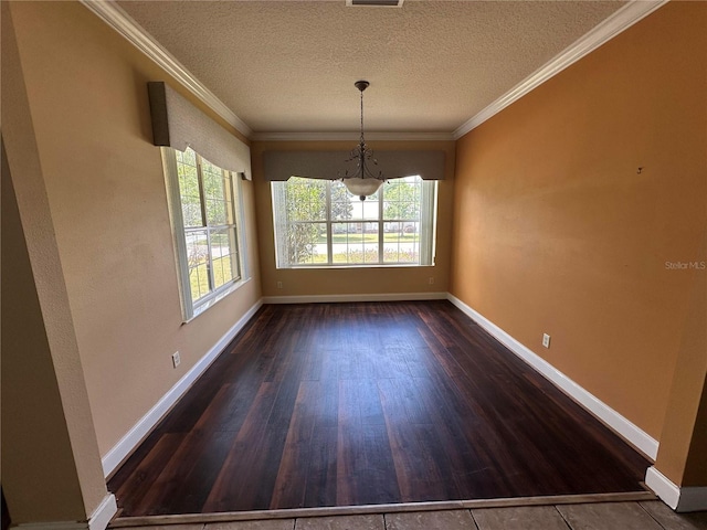 spare room featuring a textured ceiling, crown molding, and wood-type flooring