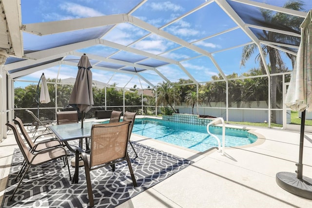 view of pool featuring glass enclosure and a patio