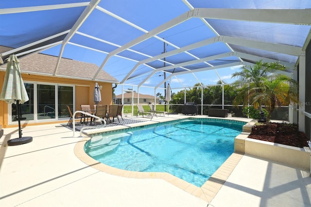 view of pool with a patio area and a lanai