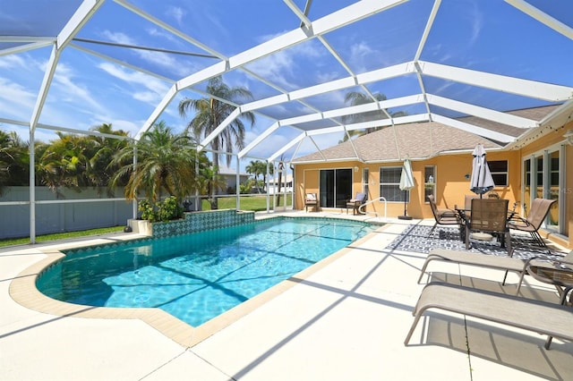 view of swimming pool featuring a patio and a lanai