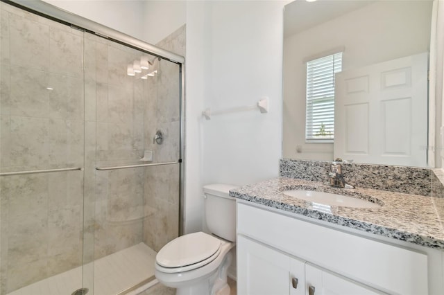 bathroom featuring vanity, toilet, and walk in shower