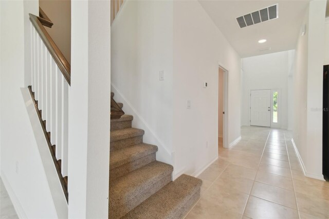 stairs featuring tile patterned floors
