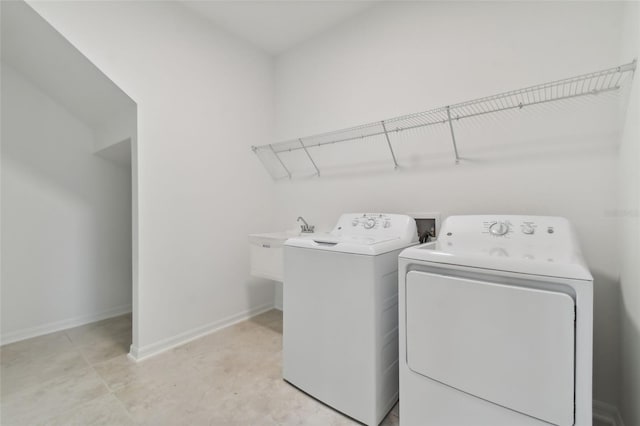 laundry room with washing machine and dryer and sink