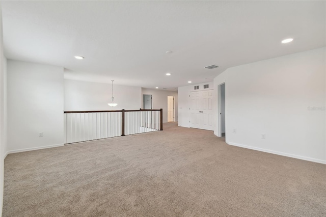 empty room featuring light colored carpet