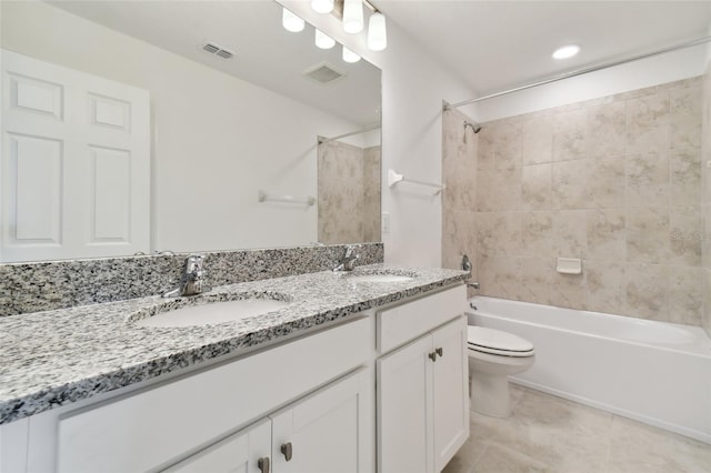 full bathroom with vanity, tiled shower / bath combo, tile patterned floors, and toilet