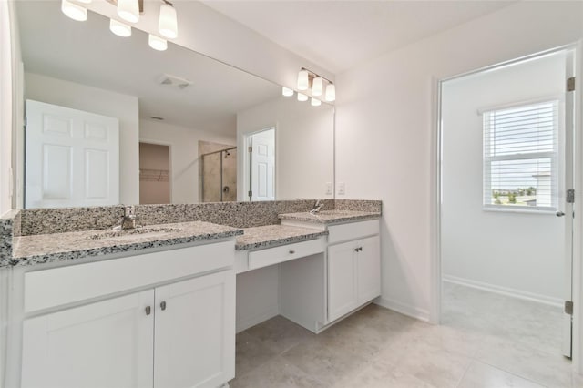 bathroom featuring vanity and a shower with shower door