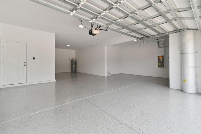 garage featuring water heater, a garage door opener, and electric panel