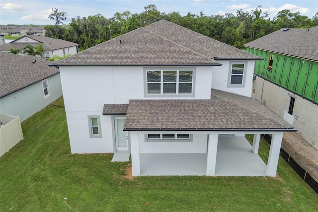 back of house featuring a patio and a lawn