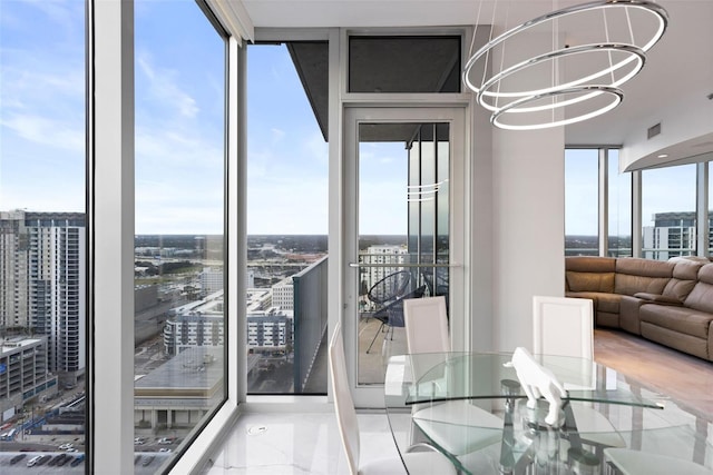 unfurnished dining area with a wealth of natural light, expansive windows, and an inviting chandelier