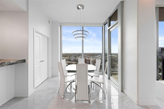 dining room featuring plenty of natural light, an inviting chandelier, and expansive windows