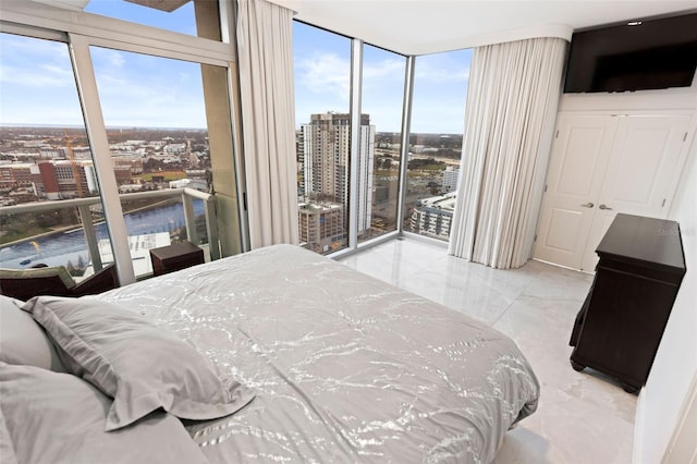 bedroom featuring access to outside and floor to ceiling windows