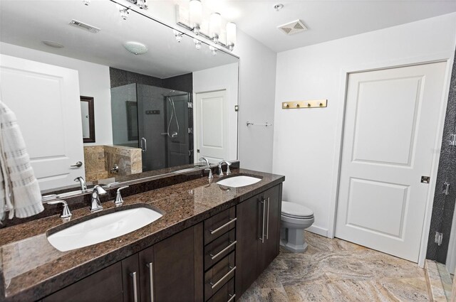 bathroom featuring vanity, toilet, and walk in shower