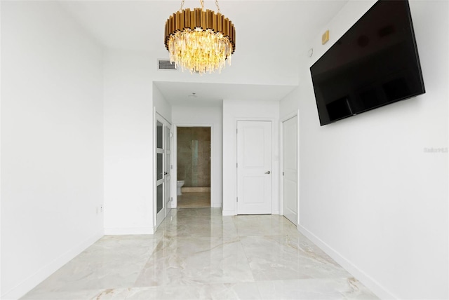 hallway featuring a chandelier