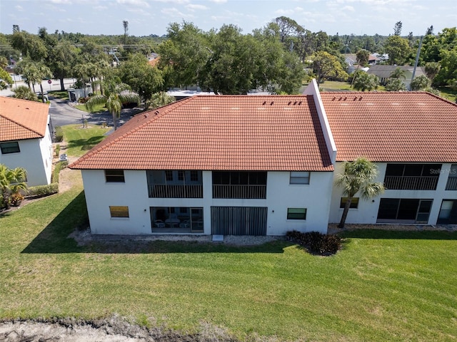 rear view of property with a yard