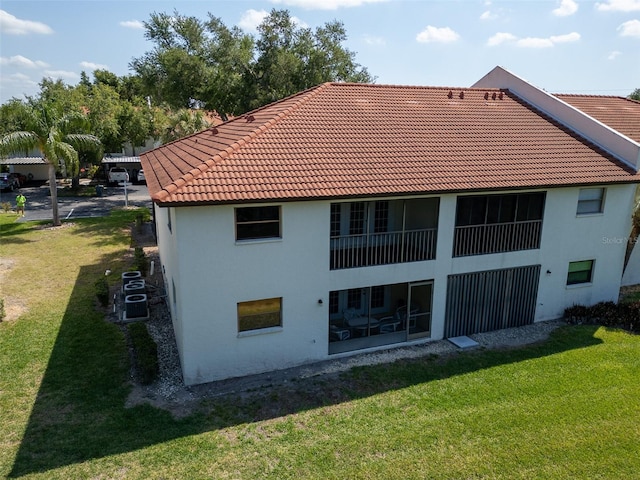 back of house with a lawn