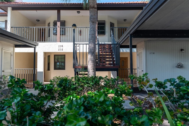 view of exterior entry featuring a balcony