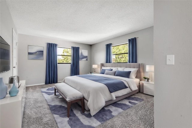 carpeted bedroom featuring a textured ceiling and multiple windows