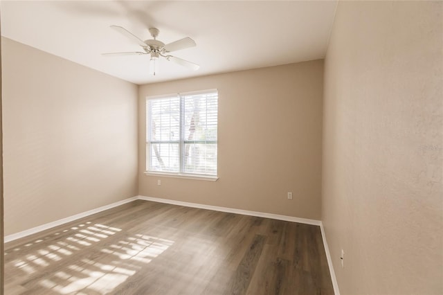 unfurnished room with ceiling fan and hardwood / wood-style flooring