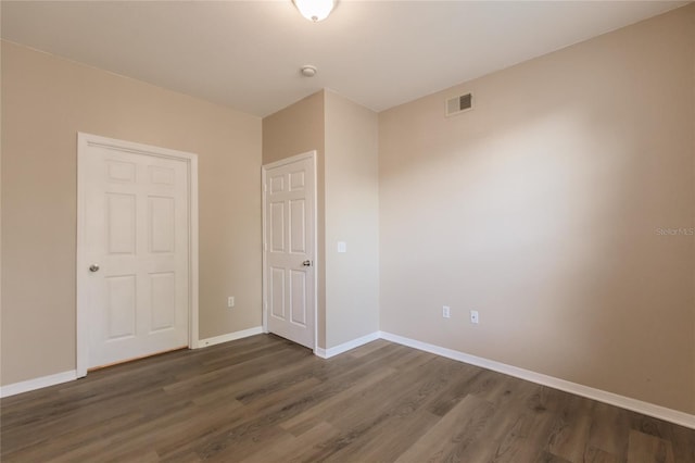 unfurnished bedroom featuring dark wood-type flooring