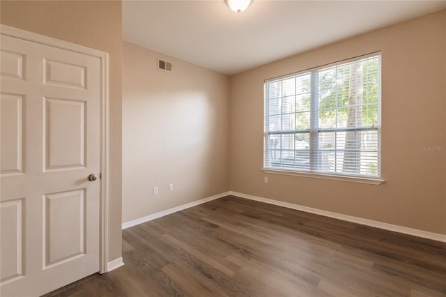 spare room with dark hardwood / wood-style floors