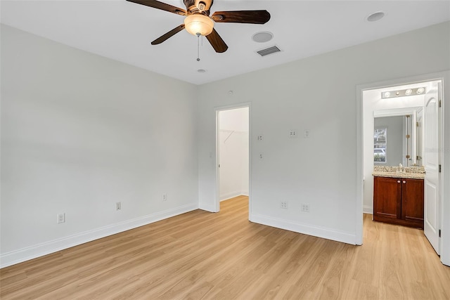 interior space featuring light hardwood / wood-style flooring, ceiling fan, and sink