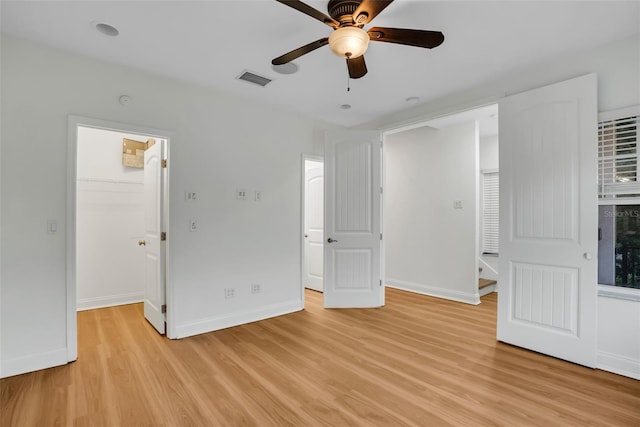 spare room featuring ceiling fan and light wood-type flooring